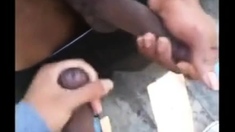 Two men cum together outside